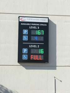 An automated parking guidance system sign on the exterior of the garage displaying available spaces by level