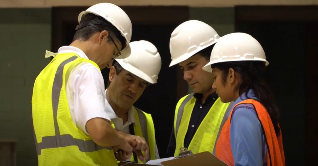 Walker employees conferring on a job site