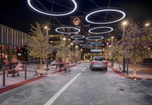 Gilbert Heritage District plaza at night with people and cars