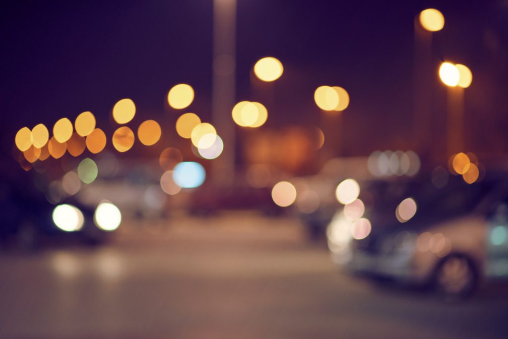 An urban parking lot at night, out of focus