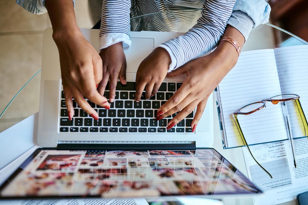 Two people using a laptop together