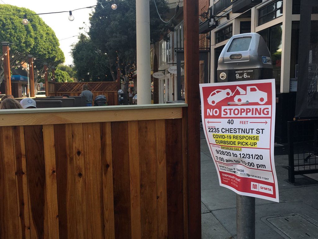 A curbside pickup zone and outdoor dining area during COVID-19