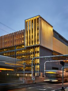 Buses pass the South Waterfront Transportation Center at dusk