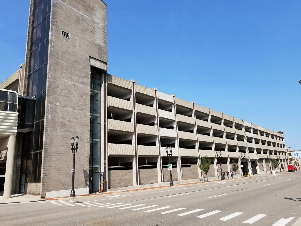 Exterior of aging concrete parking structure before renovation