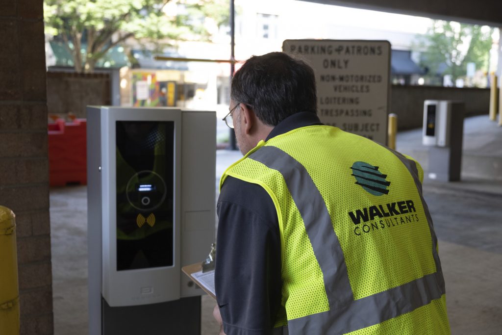 A Walker expert inspects parking access and revenue control equipment after installation