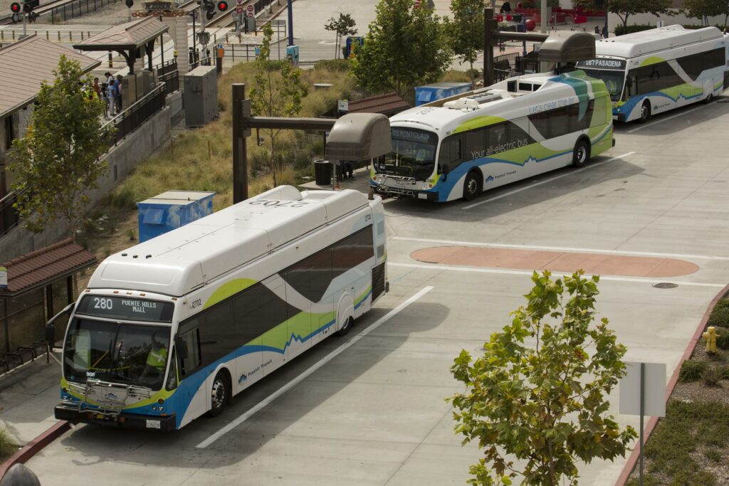 Electric buses charging at a station